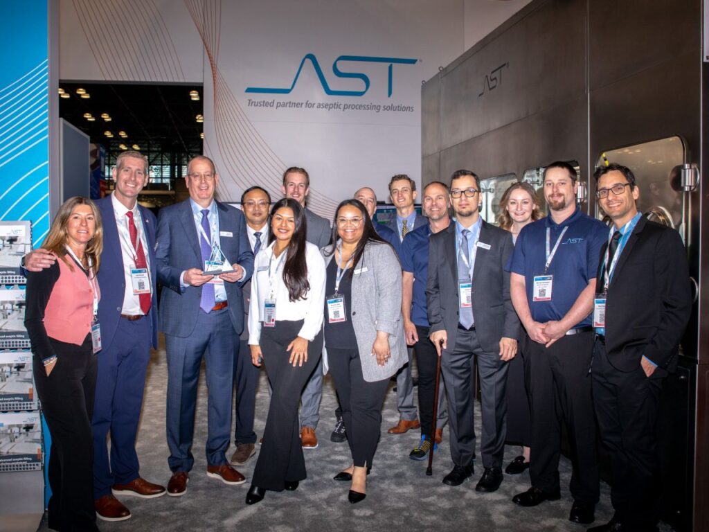 A photo showing the AST aseptic processing solutions team at the Javitz Center in New York City