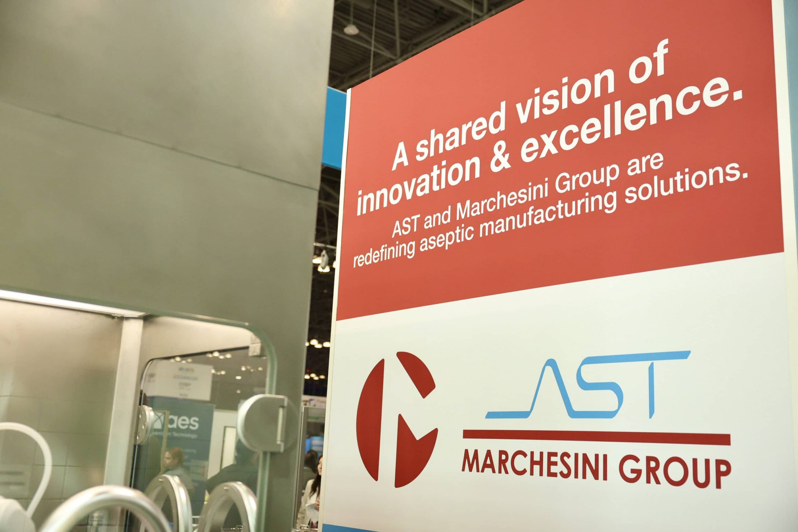 AST and Marchesini Group display banner at the INTERPHEX 2026 show that mentions redefining aseptic manufacturing solutions.