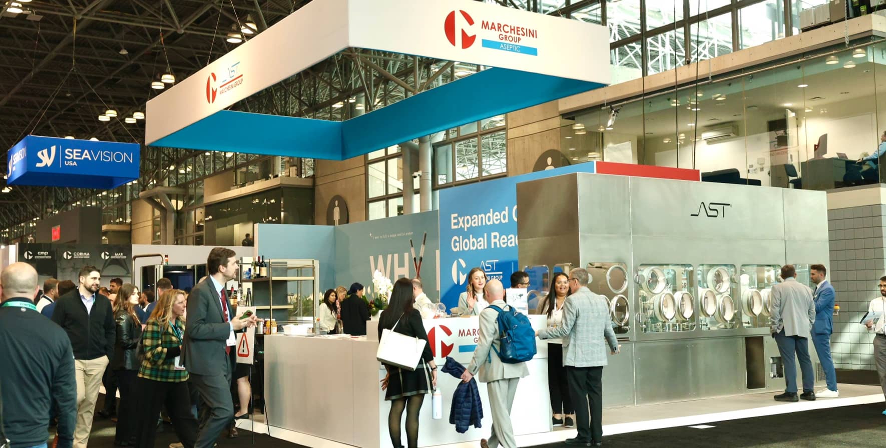 The AST and Marchesini Group exhibit on the show floor at INTERPHEX 2026, showcasing aseptic fill-finish innovations.