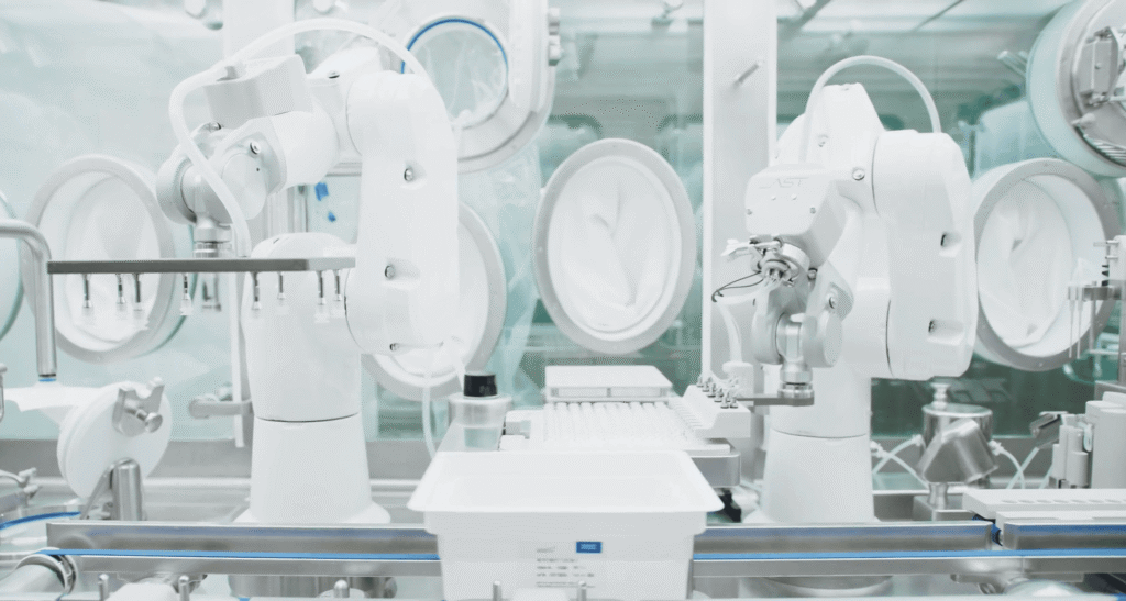 AST GENiSYS R robotic aseptic filling and closing system automating pharmaceutical container handling inside an integrated isolator